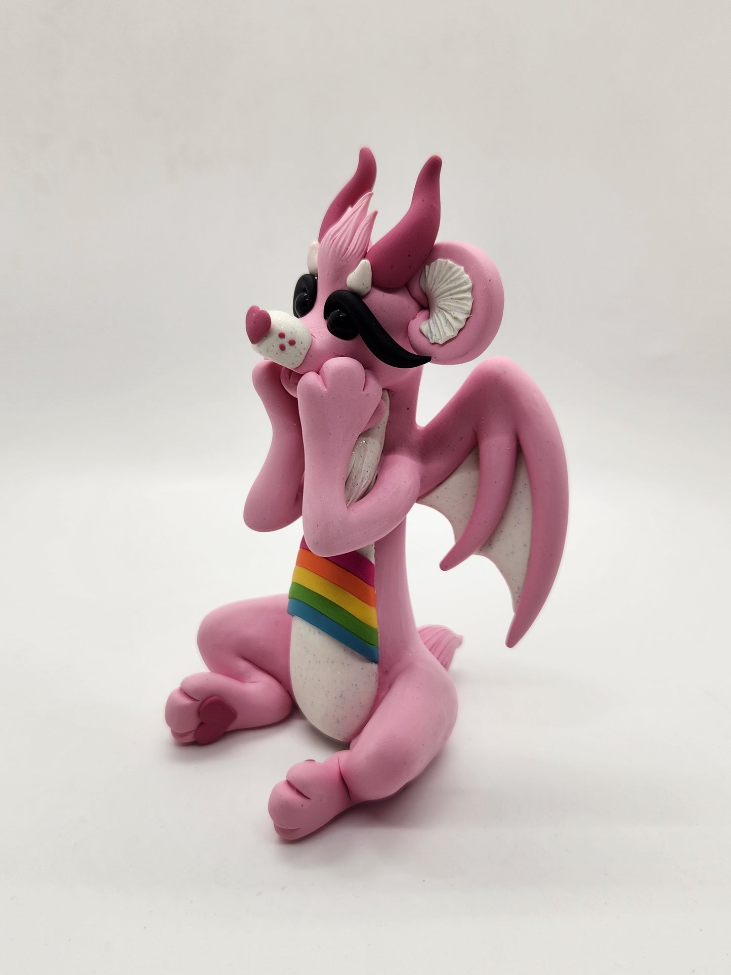 "Cheer" pink and rainbow care bear dragon sculpture