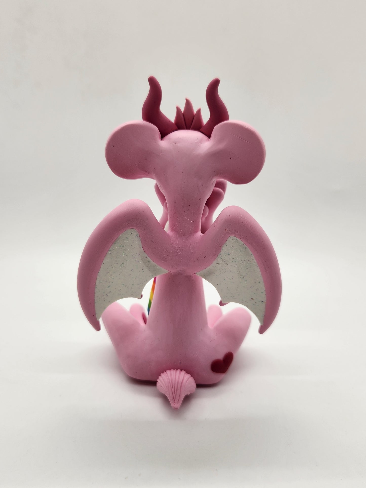 "Cheer" pink and rainbow care bear dragon sculpture