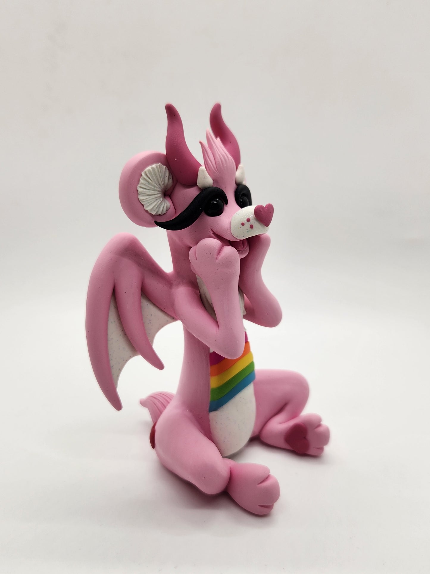 "Cheer" pink and rainbow care bear dragon sculpture