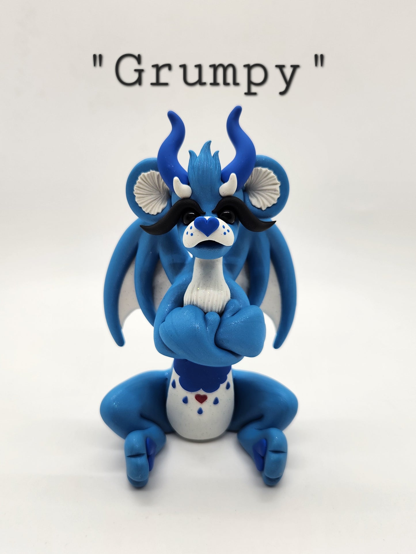 "Grumpy" blue care bear dragon sculpture