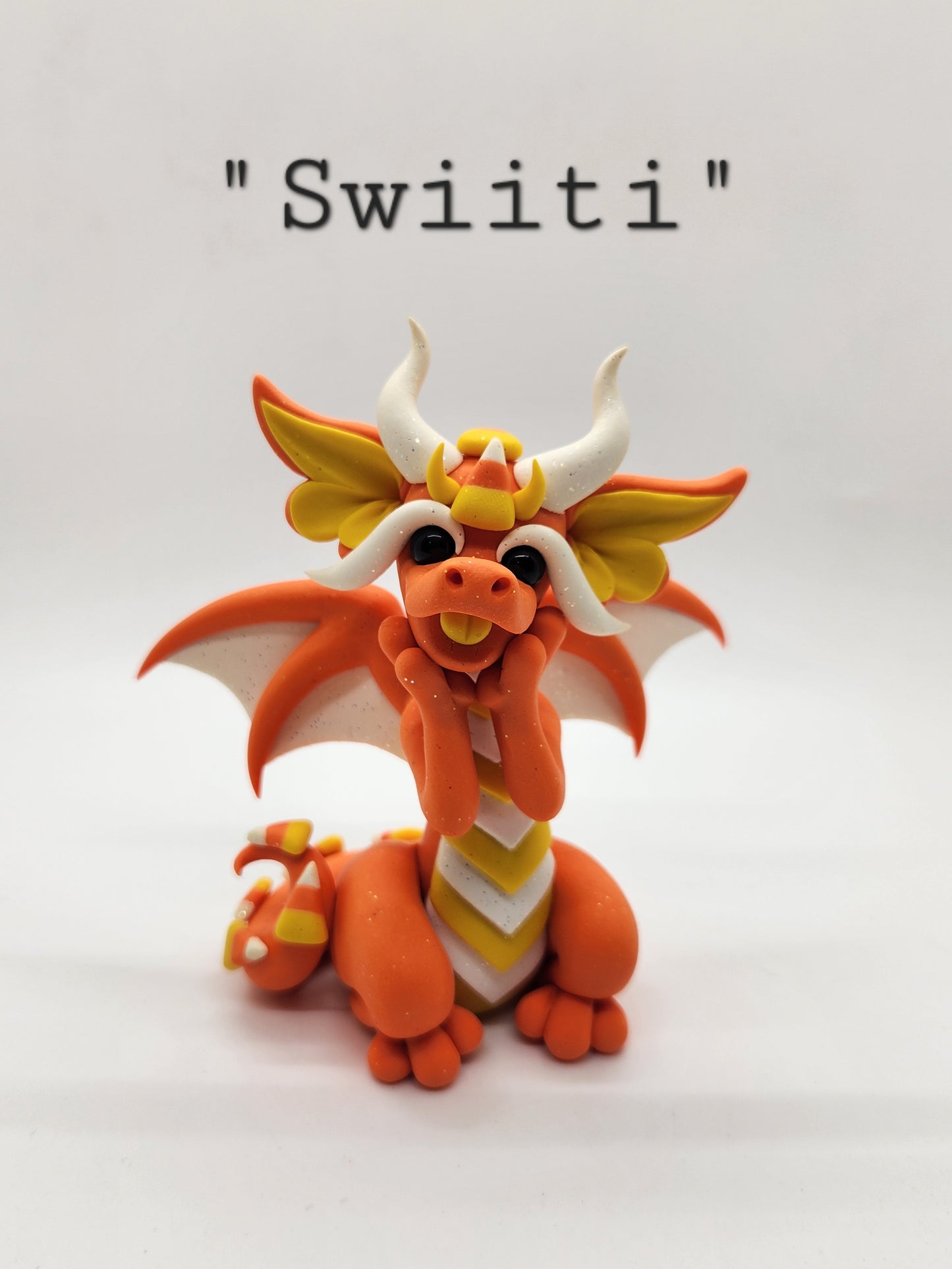 "Swiiti" orange candy corn dragon sculpture