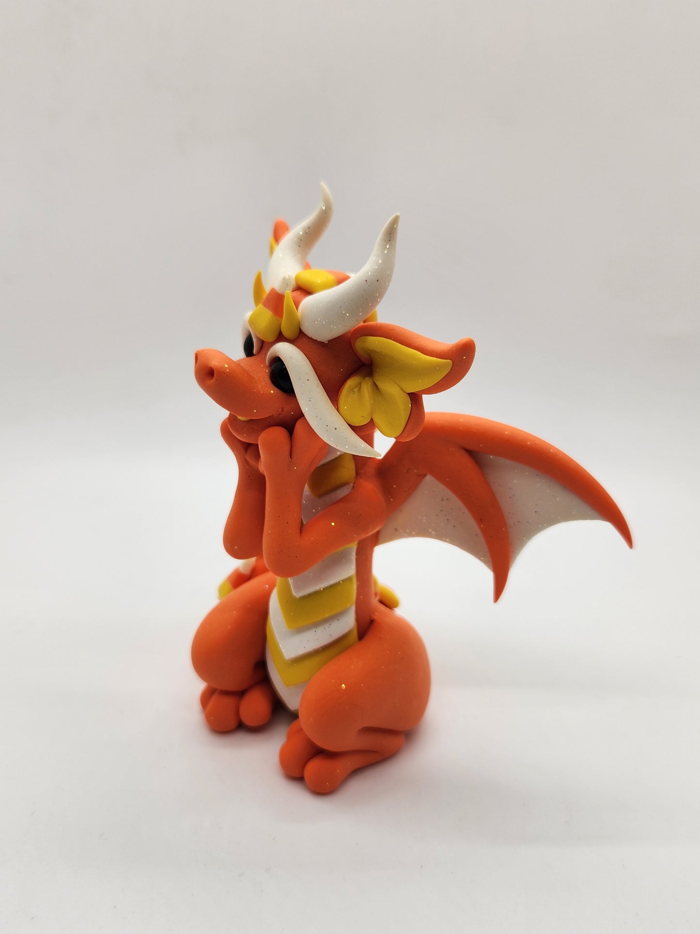 "Swiiti" orange candy corn dragon sculpture