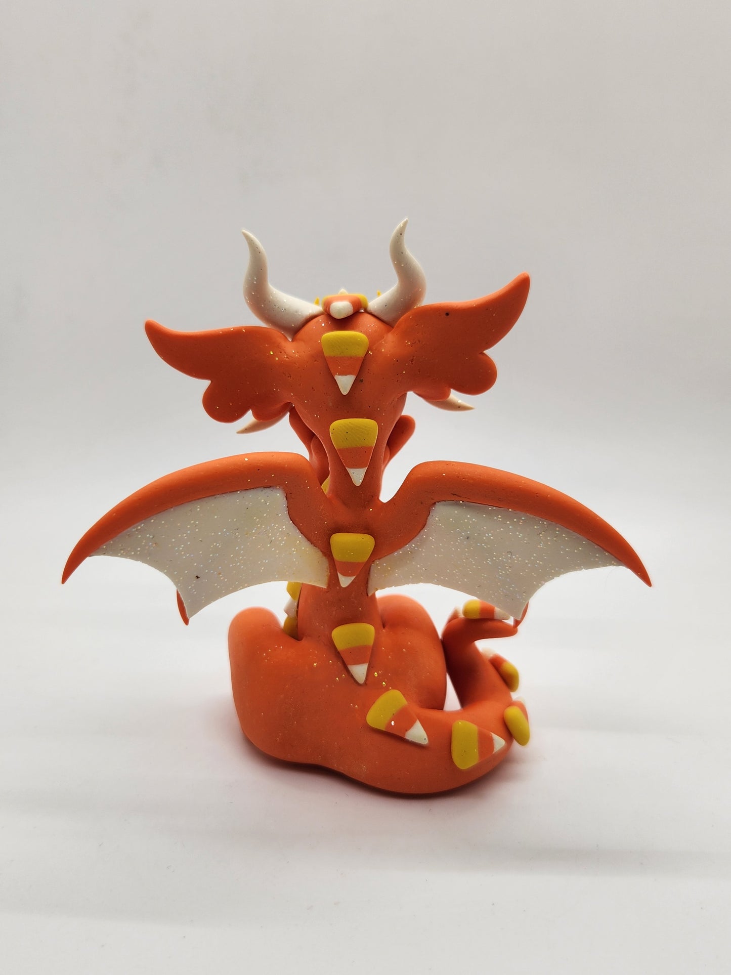 "Swiiti" orange candy corn dragon sculpture