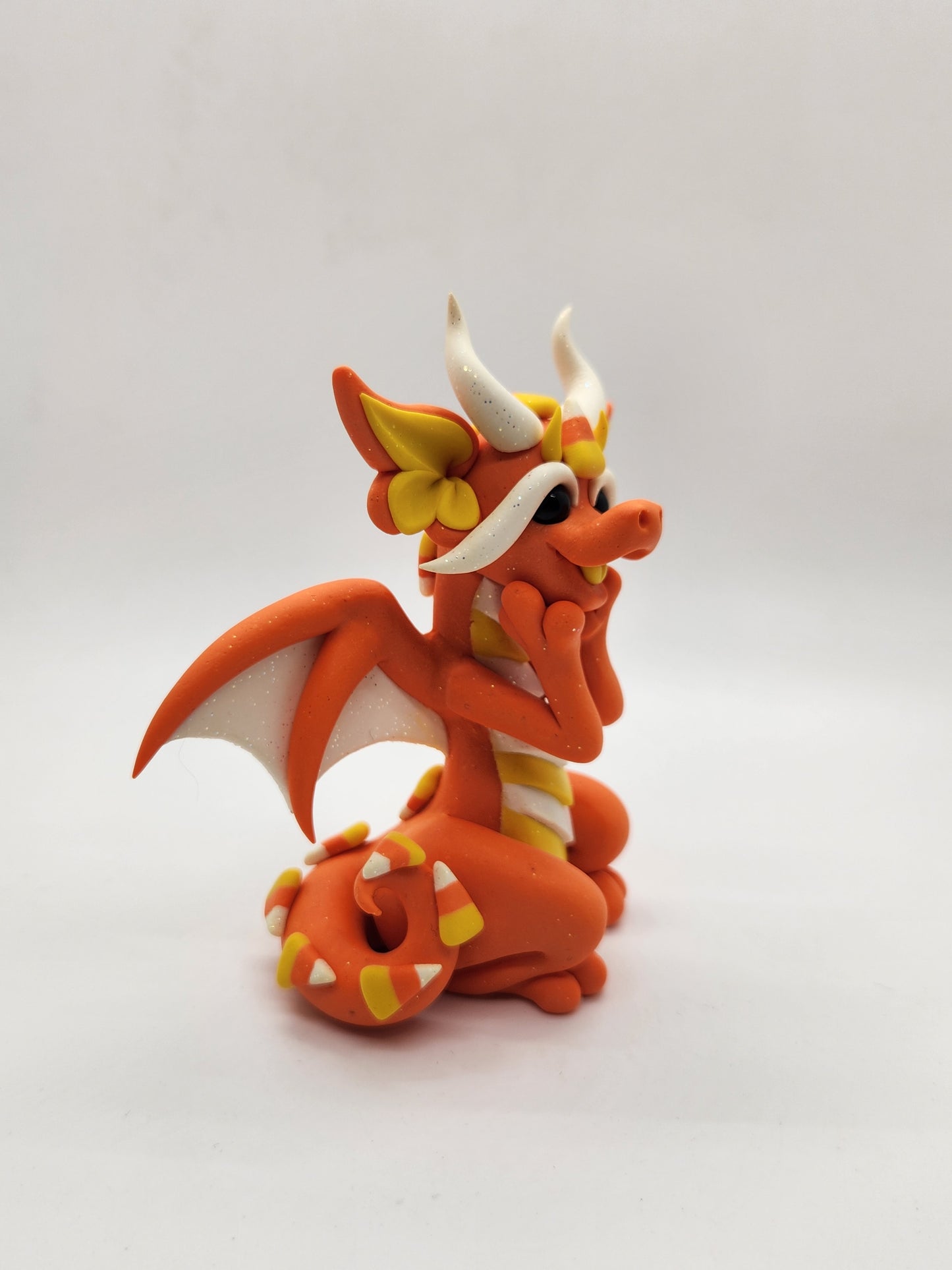 "Swiiti" orange candy corn dragon sculpture