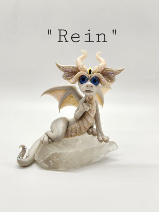 "Rein" white dragon sculpture with clear quartz chunk