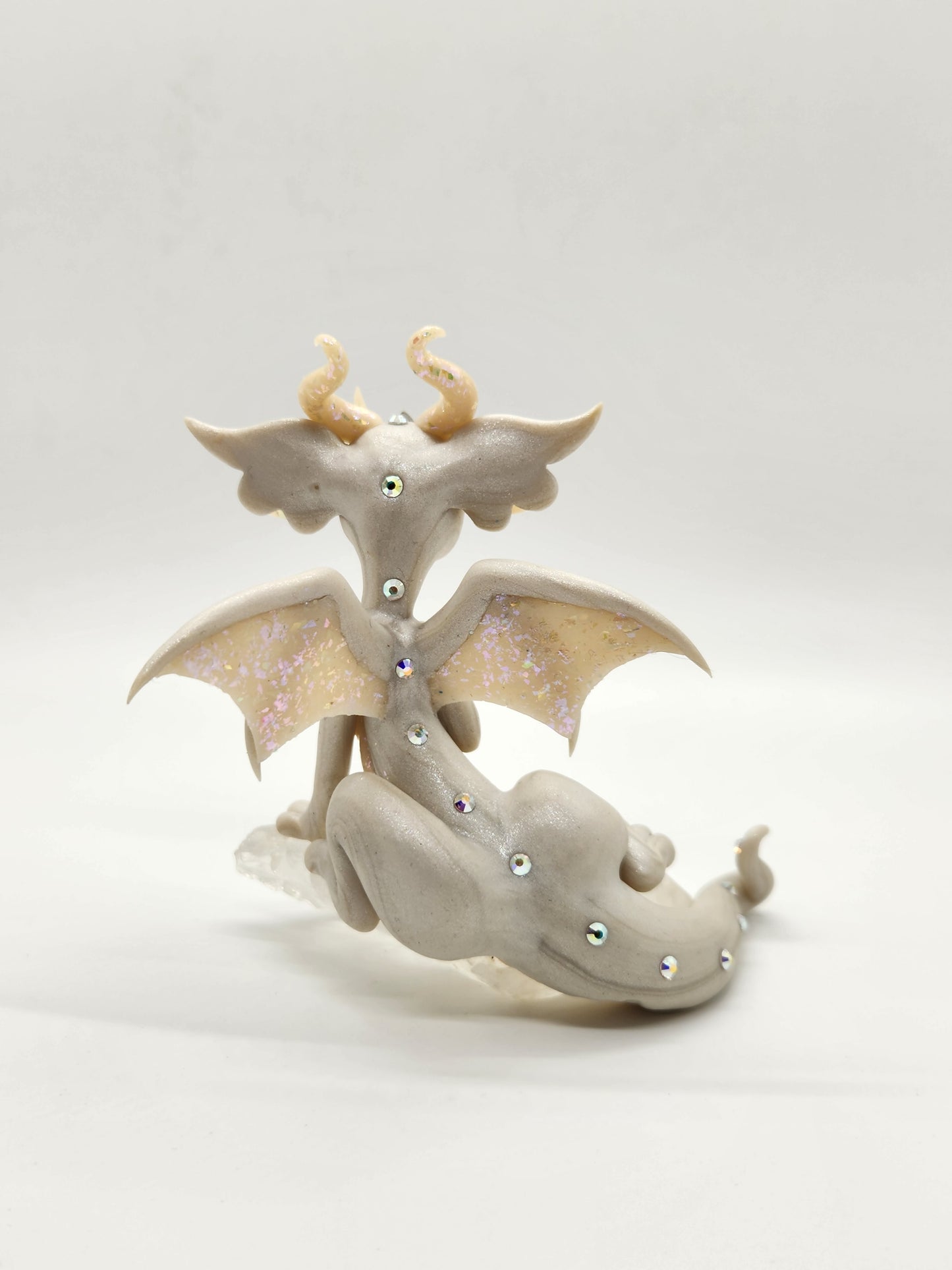 "Rein" white dragon sculpture with clear quartz chunk