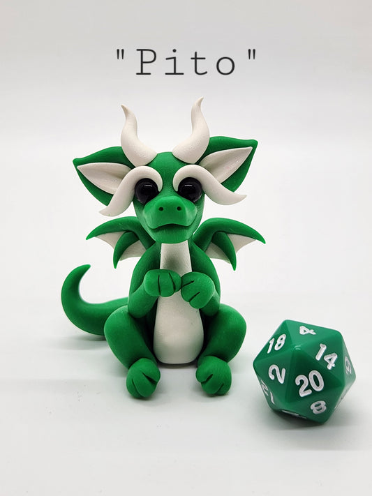 "Pito" green squish baby dragon sculpture with d20