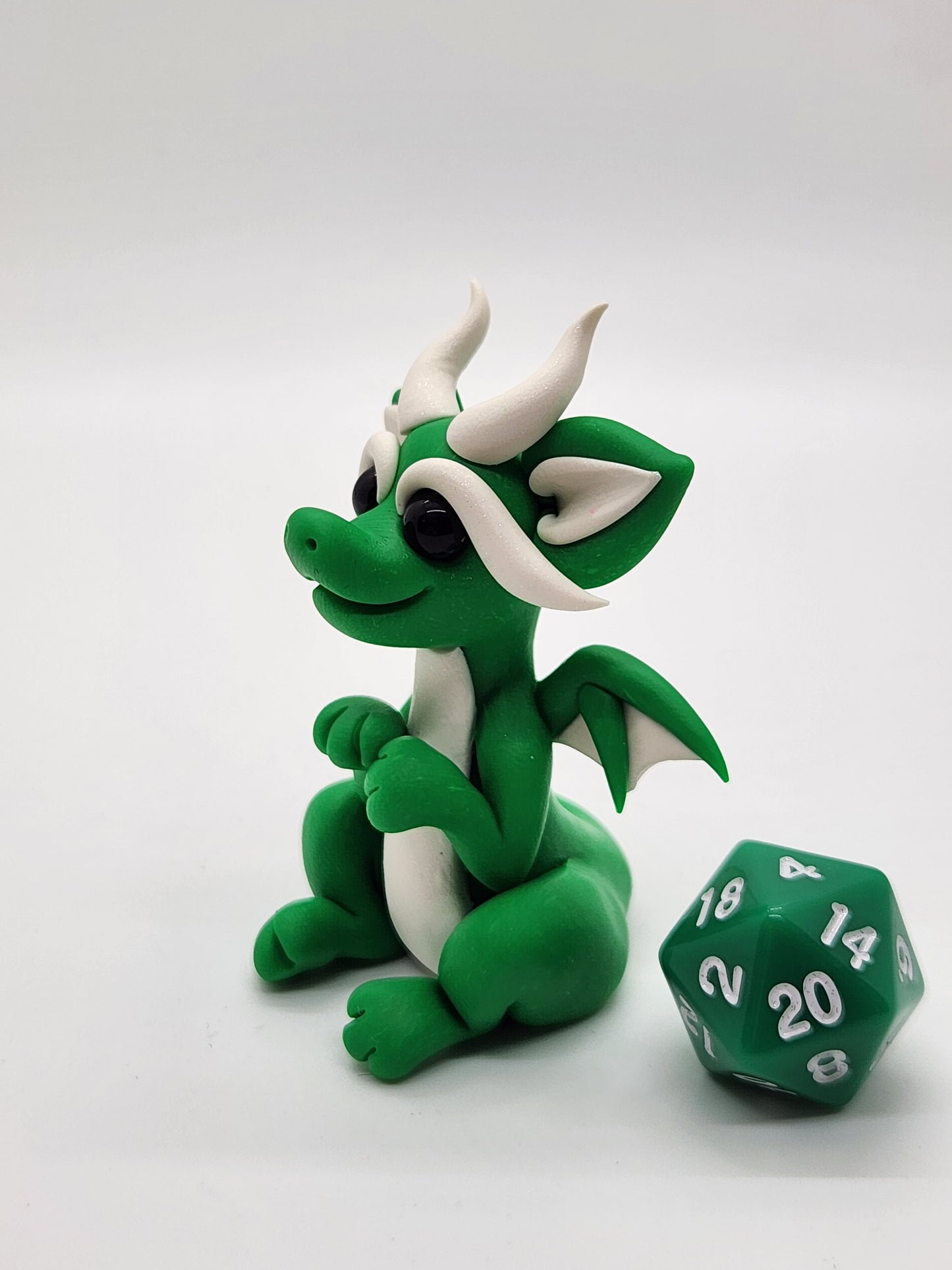 "Pito" green squish baby dragon sculpture with d20