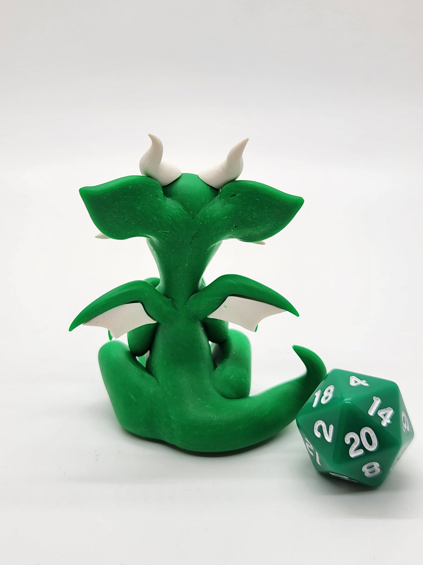 "Pito" green squish baby dragon sculpture with d20